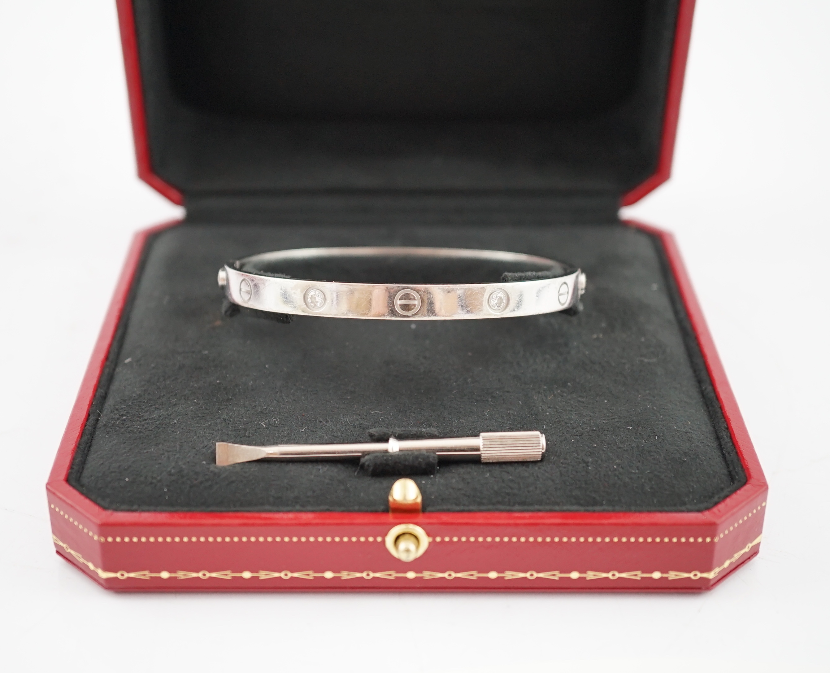 A modern Cartier 750 white gold and four stone gypsy set diamond 'Love' bangle